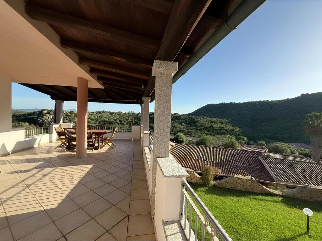 a patio with a table and chairs on a roof at Villa Olbia mare in Olbia