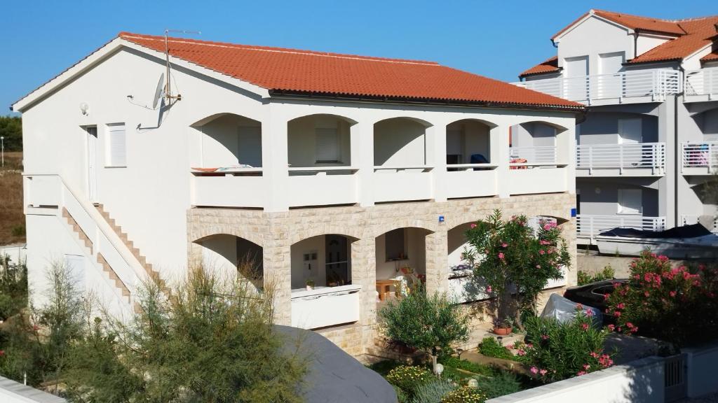 a white building with a red roof at Apartman Adriatic View in Vir