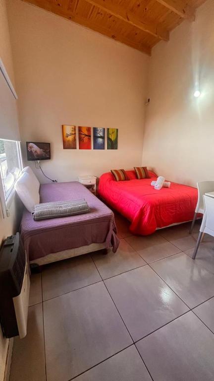 a room with two beds in a room at Casa Choique in Villa El Chocón