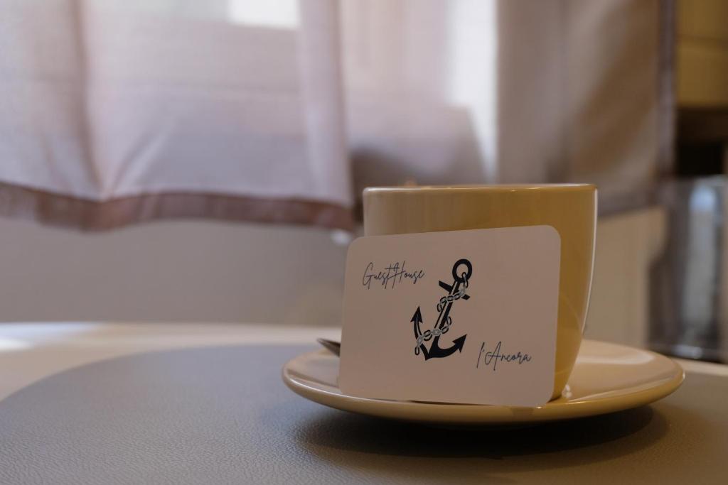 a coffee cup sitting on a plate on a table at L'Ancora in Rapallo