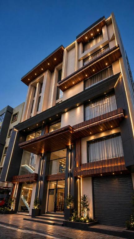 a large building with many windows on a street at Hotel Madhukta Inn in Somnath
