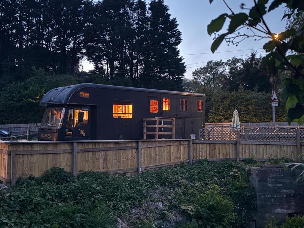 a black train car with its lights on at Parrys Horse box in Exmouth