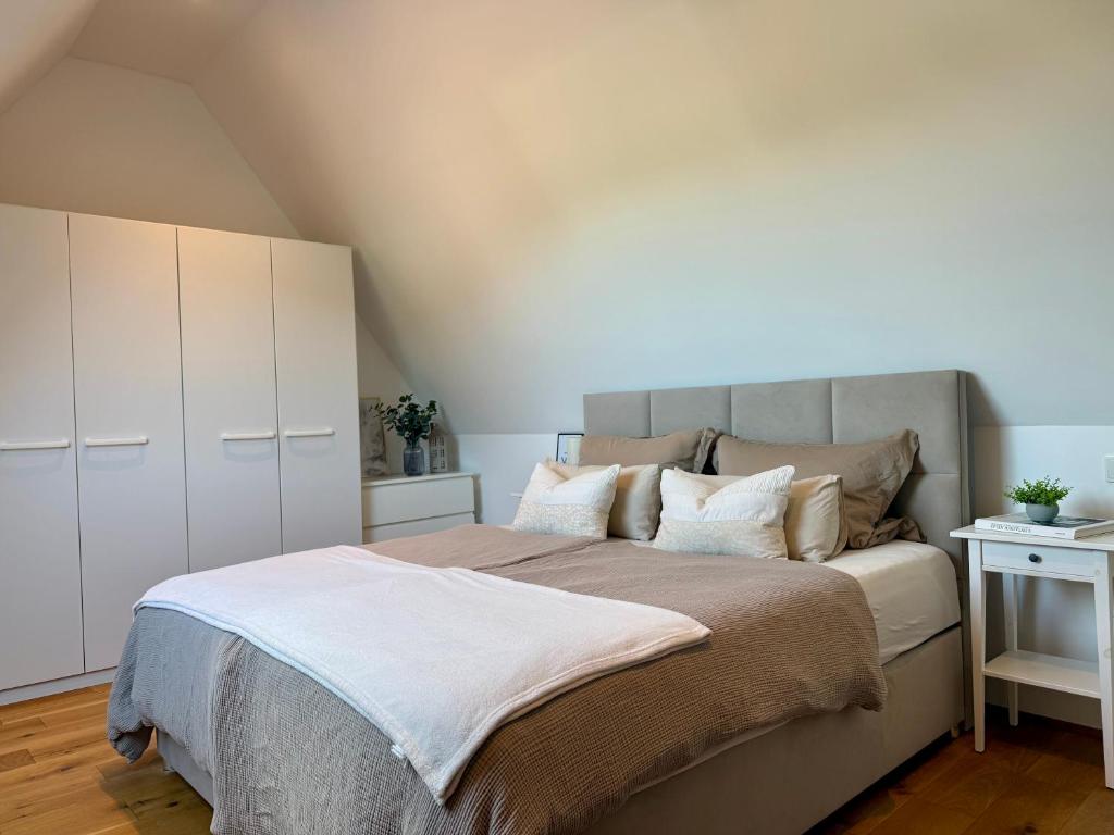 a bedroom with a large bed with white cabinets at Wohnung Dorfblick in Hauenstein