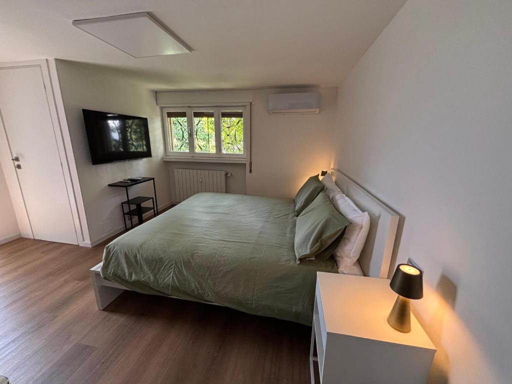 a bedroom with a bed and a table with a lamp at B&B Del Paradiso in Bergamo