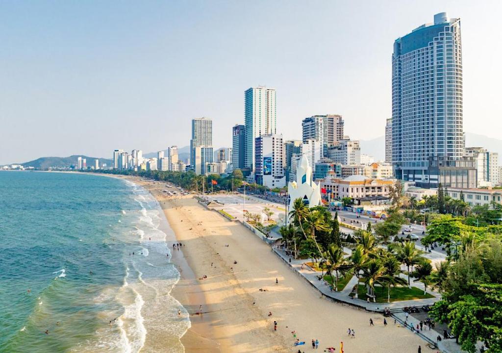 an aerial view of a beach with buildings and the ocean at Panorama Blue Beach Nha Trang in Nha Trang