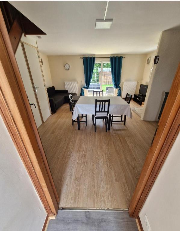 a view of a living room with a table and chairs at Gîte au coeur du pays dinannais in Plumaudan