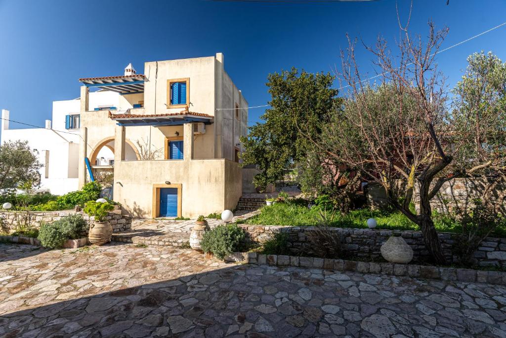 a house with a stone driveway in front of it at Kythaeri Studios in Frátsia