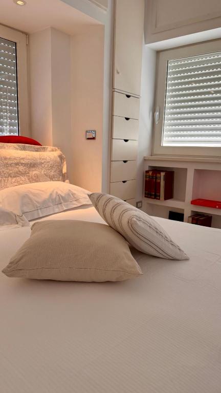 a bedroom with a white bed with two pillows at Messapia Homes in Mesagne