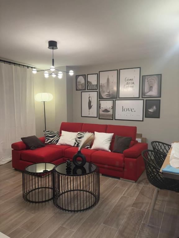 a living room with a red couch and a table at Las Casas de Lola in Candeleda