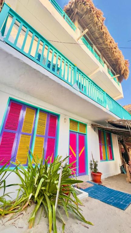 a house with colorful shutters on the side of it at Casa Violeta Beach House in Rincón