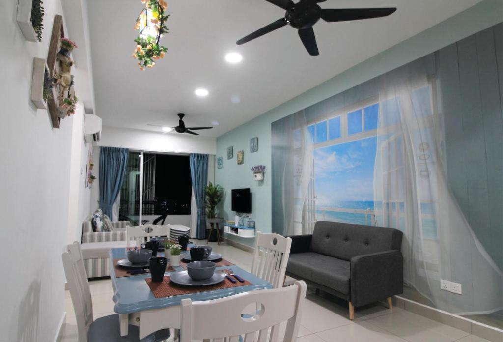 a living room with a table and a couch at Majestic Cottage in Ipoh