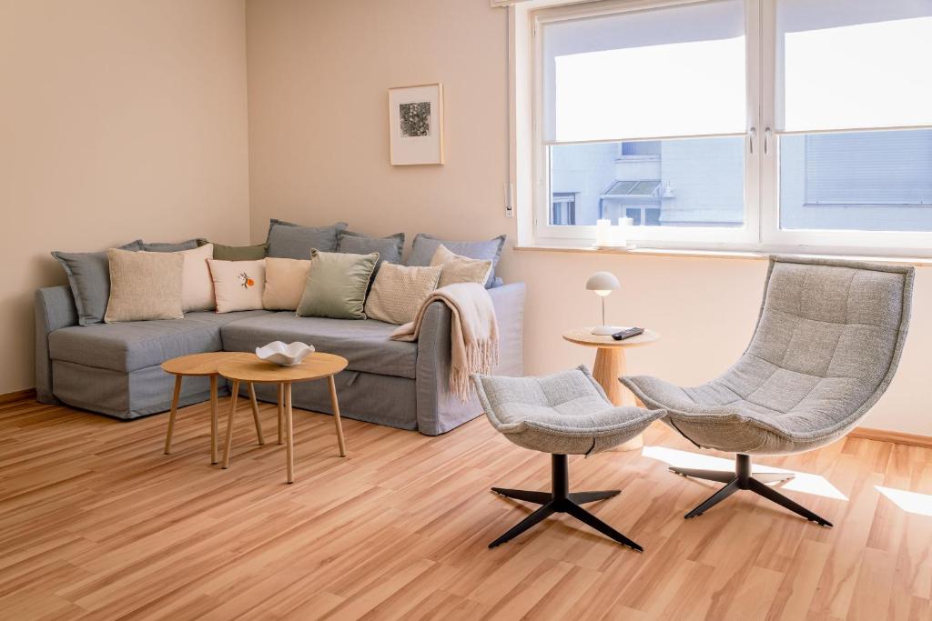 a living room with a couch and two chairs at Wald & Weg in Schmallenberg