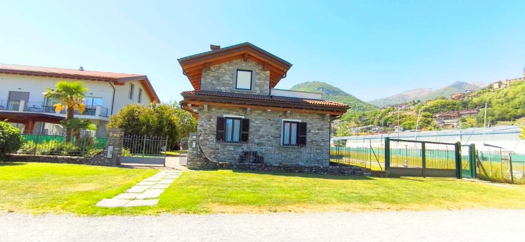 a building with a clock tower in the grass at Villetta Maurizia in Domaso