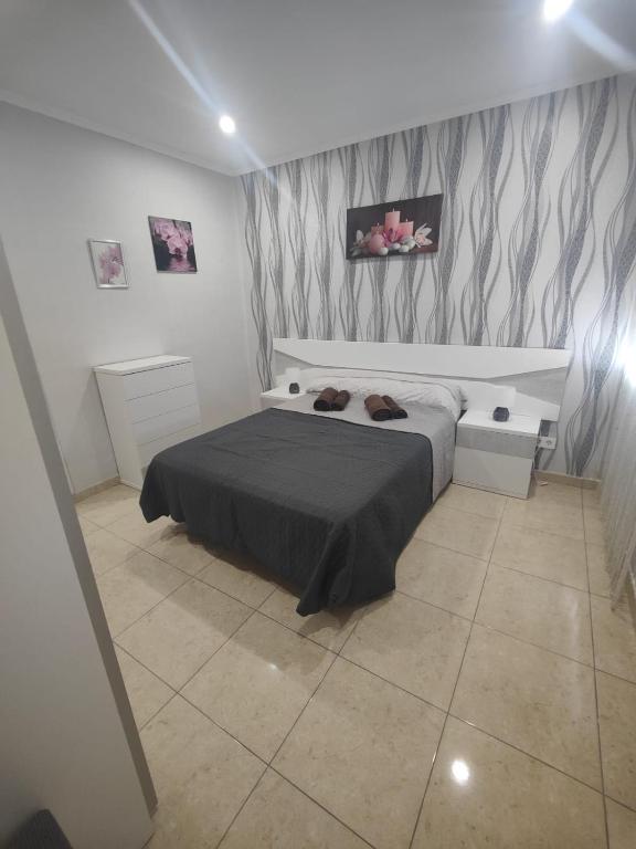 a bedroom with a bed with shoes on it at Vinaros Modern Apartment in Vinarós