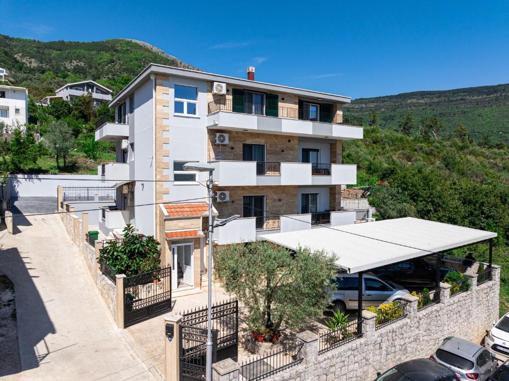 a building with a parking lot in front of it at Stars Apartments in Tivat