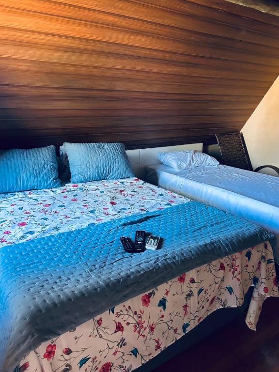 a bed in a room with a wooden head board at Pousada Maria elza in Eldorado