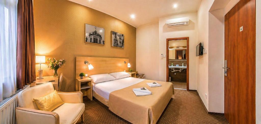 a hotel room with a bed and a desk and a chair at Budapest Citi Guesthouse - contactless self check in in Budapest