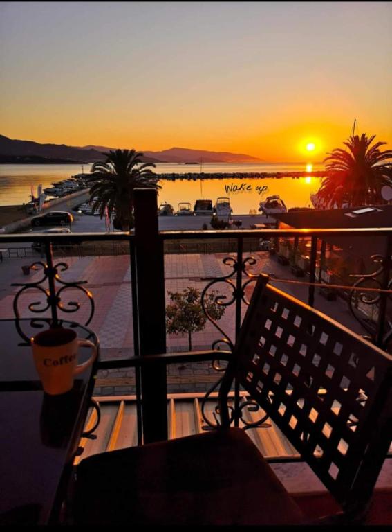 a view of a sunset from a balcony with a bench at Sunrise Horizon in Iraklitsa
