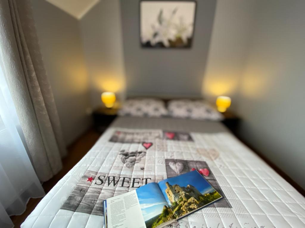 a bedroom with two beds with a newspaper on the bed at Na Jurze in Mirów