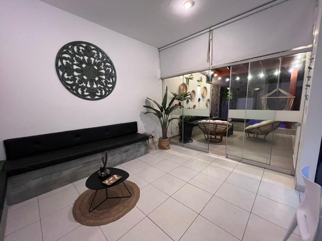 a living room with a couch and a table at Los Pulpos Beach House in Bombiso