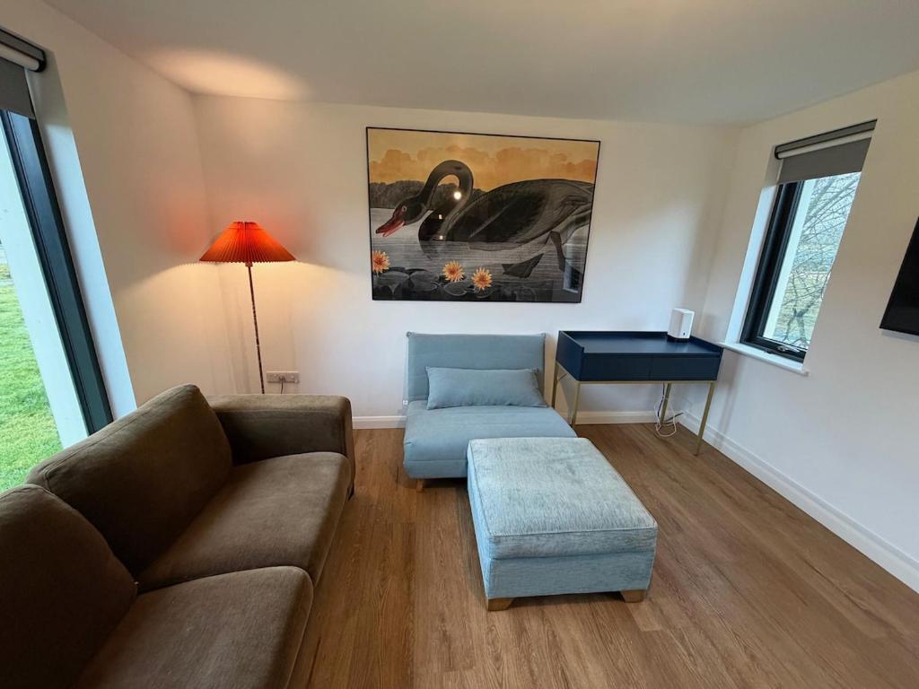 a living room with a couch and a table at The Bat Barn in Corsley