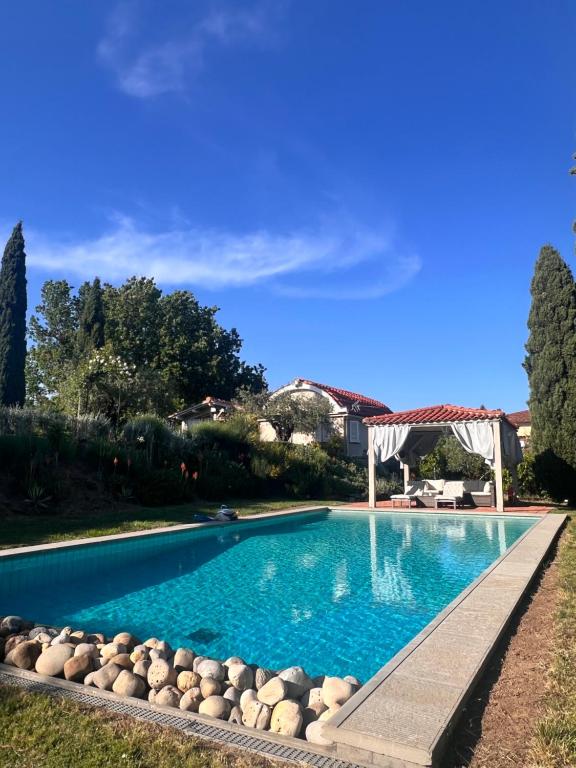 a swimming pool with blue water in a yard at Casa le valli in Cantagrillo