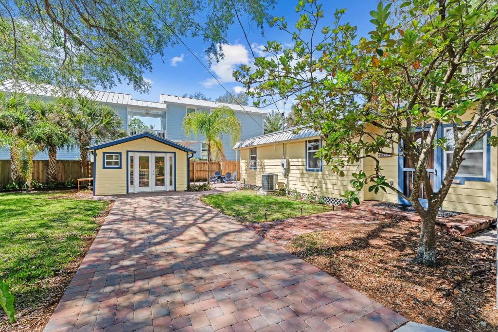 a home with a driveway and a house at Downtown Gem- Dog Friendly Walk to Everything in St. Augustine
