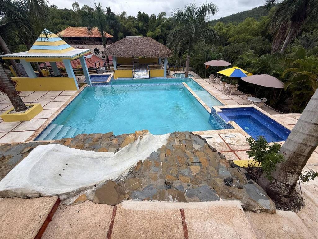 a swimming pool in a resort with a building at Segundo Piso complet in La Cuaba