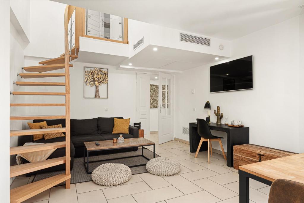 a living room with a couch and a table at 10 Rue de la Rampe in Cannes