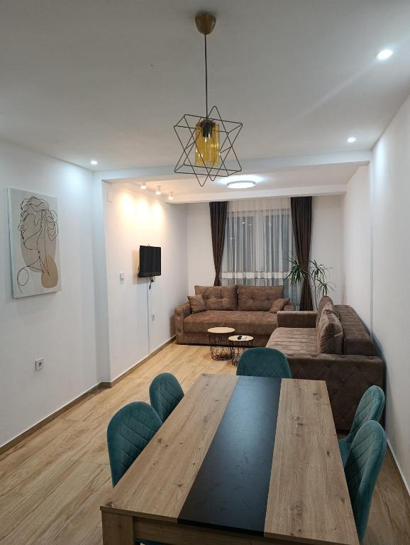 a living room with a table and a couch at Vila Ideal in Donji Štoj