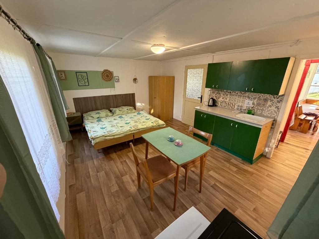 a living room with a bed and a table at Chaty Kašperské Hory in Kašperské Hory