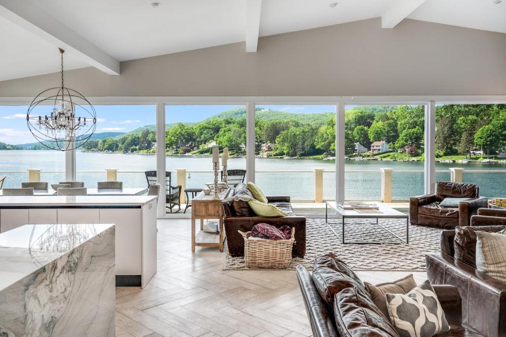 a living room with a view of the water at Waterfront Lakehouse in New Fairfield
