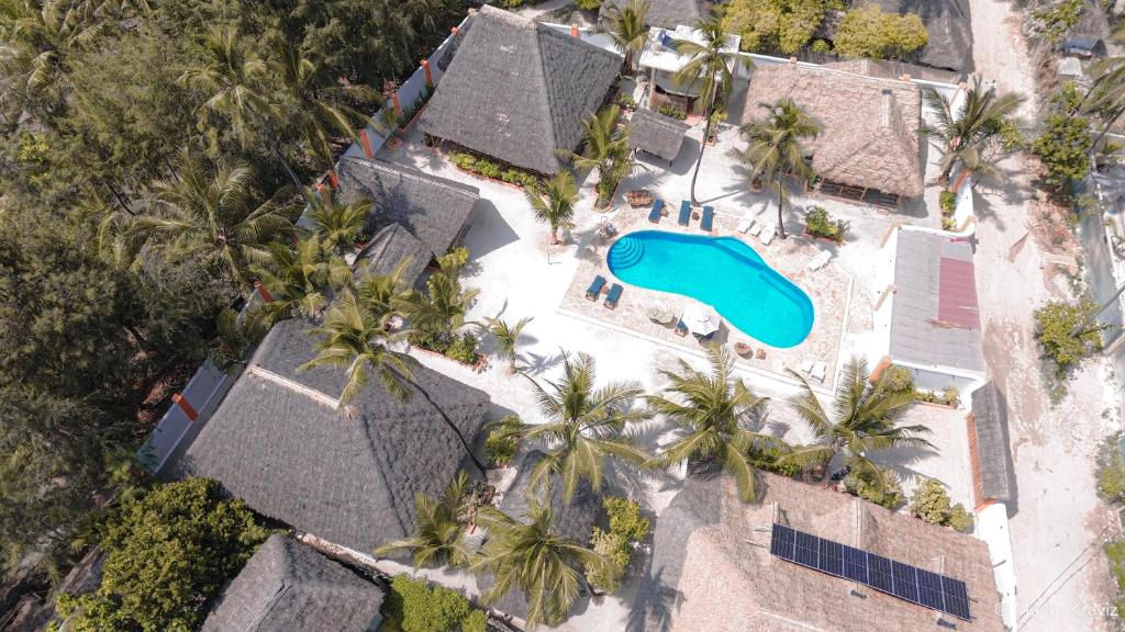 an aerial view of a resort with a swimming pool and palm trees at Sunset Mkuu Boutique Hotel in Michamvi