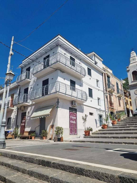 a white building with stairs in front of it at B&B Bagnara Vista Mare in Bagnara Calabra