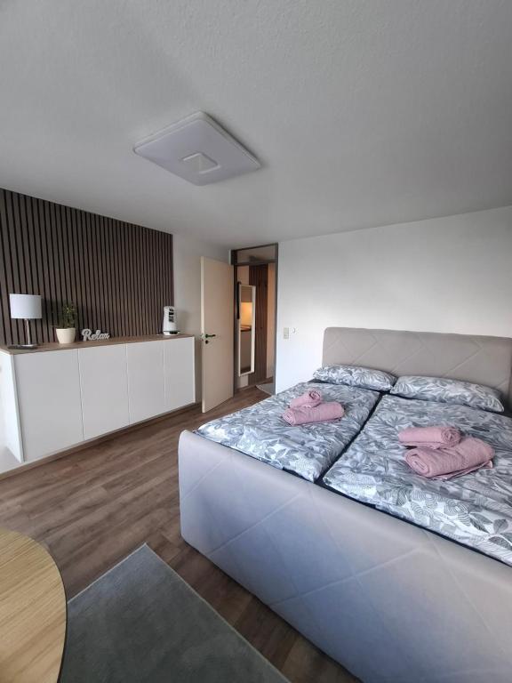 a bedroom with a bed with pink towels on it at Julia's Oase in Sasbachwalden