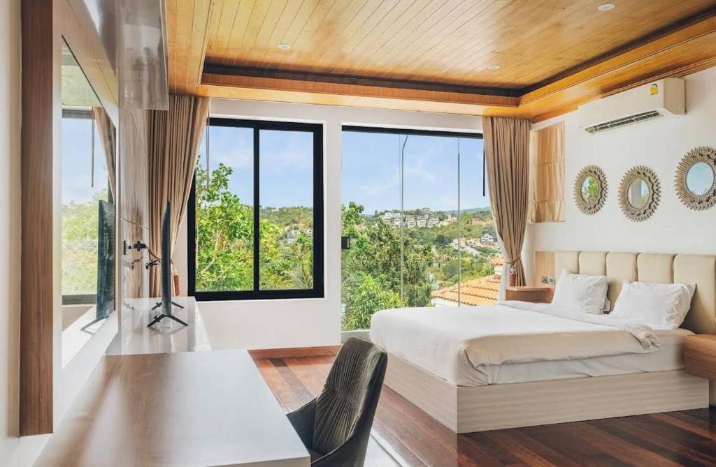 a bedroom with a bed and a large window at Anara Pool Villa - Private House in Bophut
