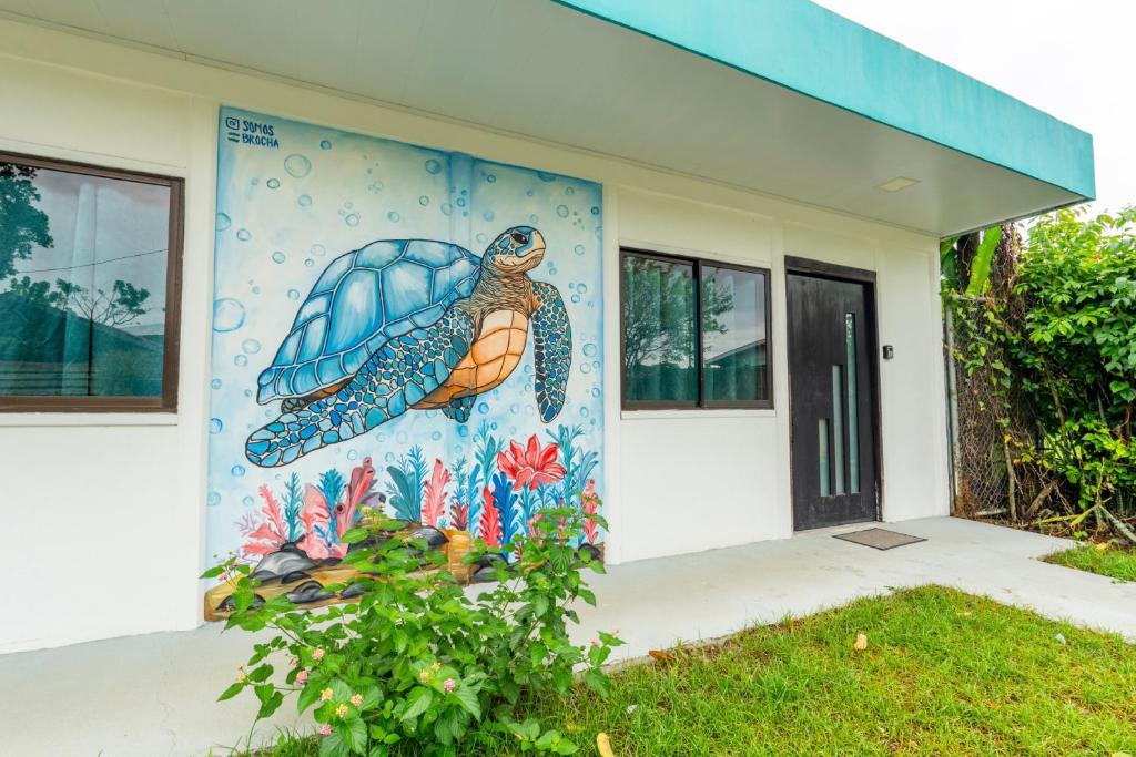 a turtle mural on the side of a building at Cahuita Apartment by Angie in Cahuita