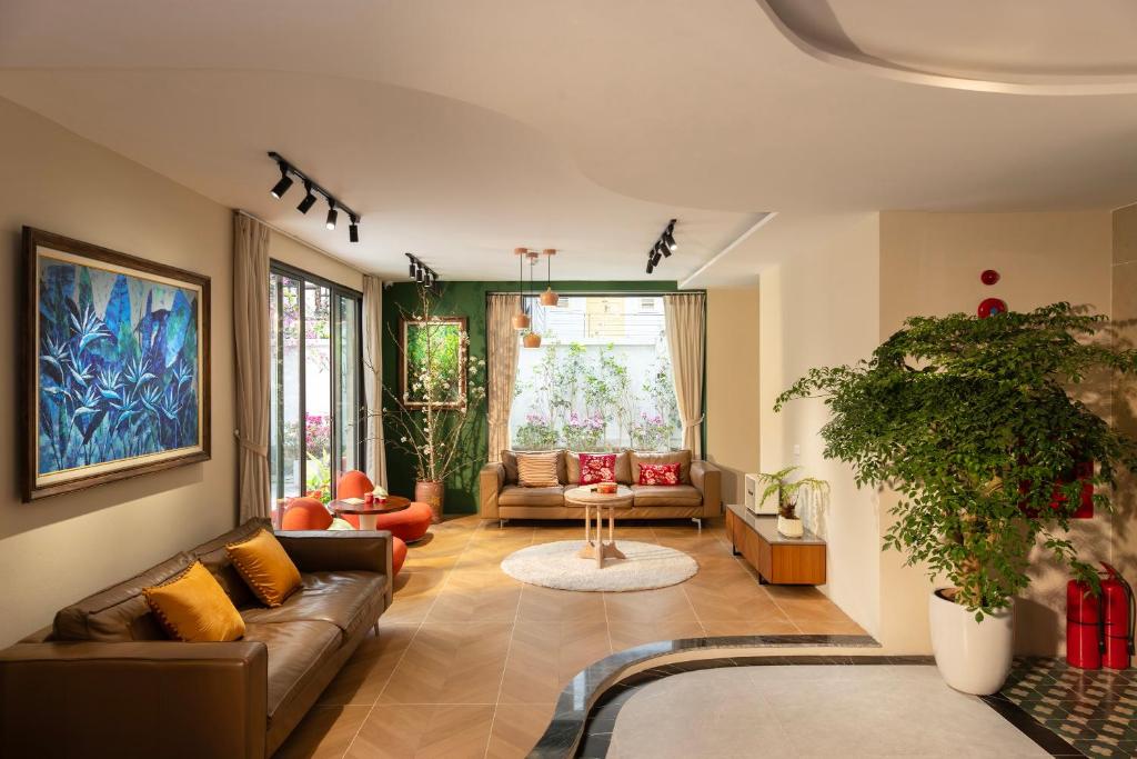 a living room with a couch and a table at Well-being Home - Self-Service in Hanoi