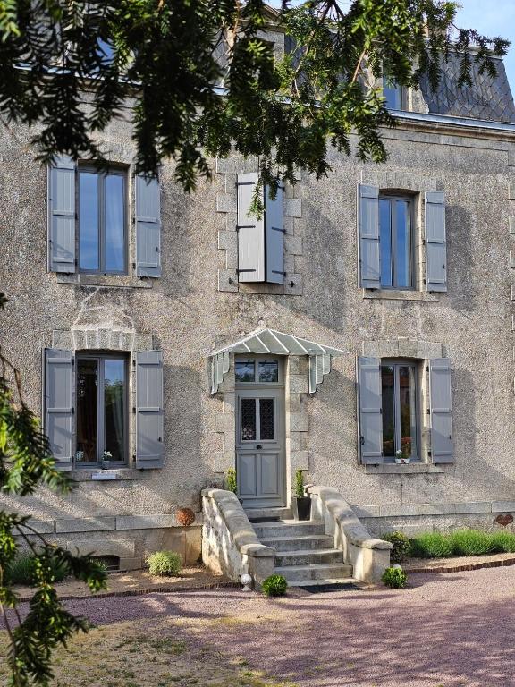 a stone building with stairs in front of it at Chambres d'hôtes "Le Petit Cardinal" - proche PuyduFou in Mauléon