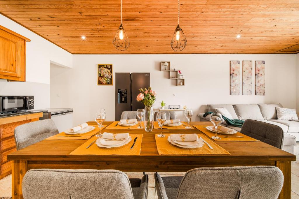 a dining room with a wooden table and chairs at Villa BELLEVUE in Bras-Panon