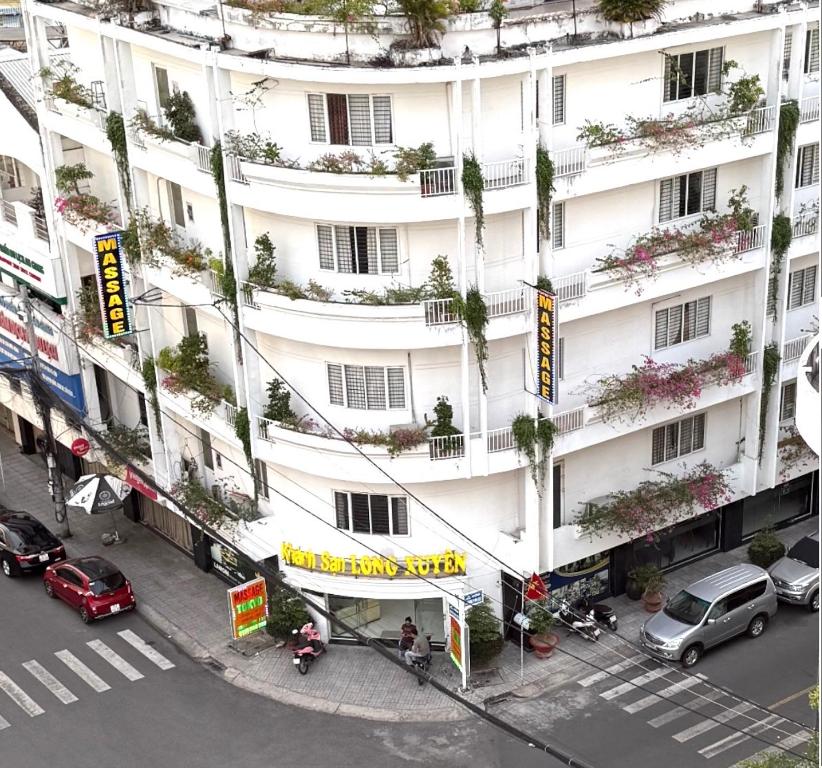 an overhead view of a large white building with plants at Khách Sạn Long Xuyên in Long Xuyên