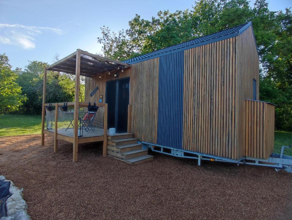 a tiny house with a staircase and a gazebo at Tiny House nature & détente, Vercors, terrasse, vue montagne in La Motte-Fanjas
