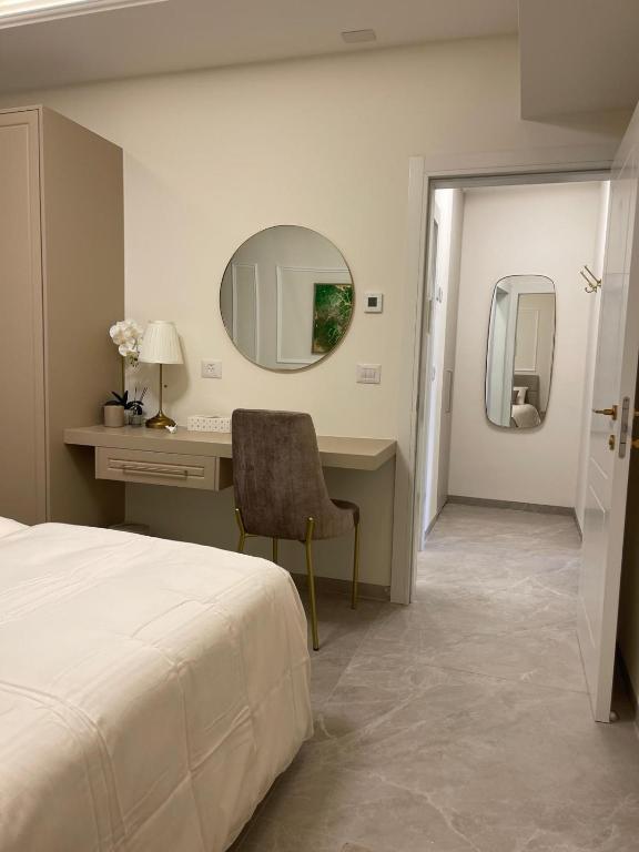 a bedroom with a bed and a desk and a mirror at Malka Suites in Beit Shemesh