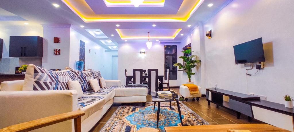 a living room with a couch and a tv at Serene Hills Home in Nairobi