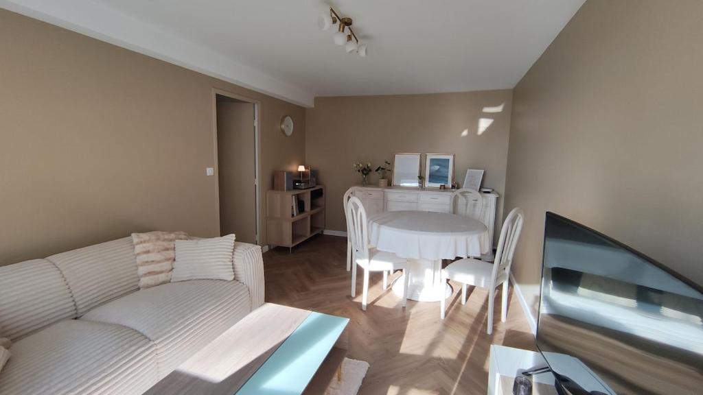 a living room with a white couch and a table at Appartement à Anglet in Anglet