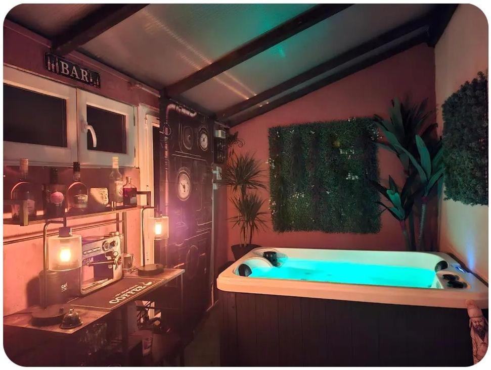 a bathroom with a blue tub in a room at Maison avec jacuzzi in Vierzon