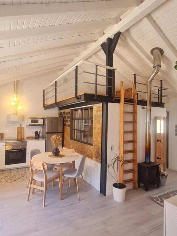 a loft bed in a room with a table and chairs at Alba Odeceixe - casa aurea in Odeceixe