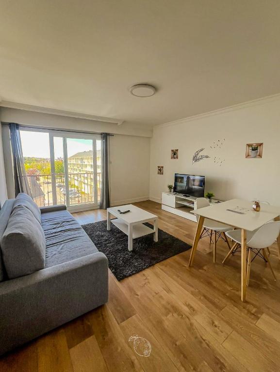 a living room with a couch and a table at BayView in Saint-Brieuc