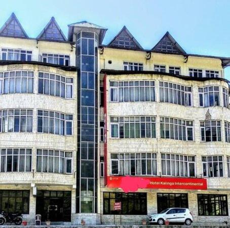 a large building with a car parked in front of it at Kalinga Intercontinental By Maa Vaishno Hotels India Pvt Ltd in Manāli