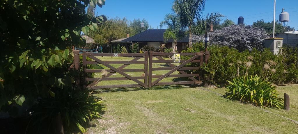 a wooden fence in a yard with a gate at Quinta la ponderosa in Brandsen